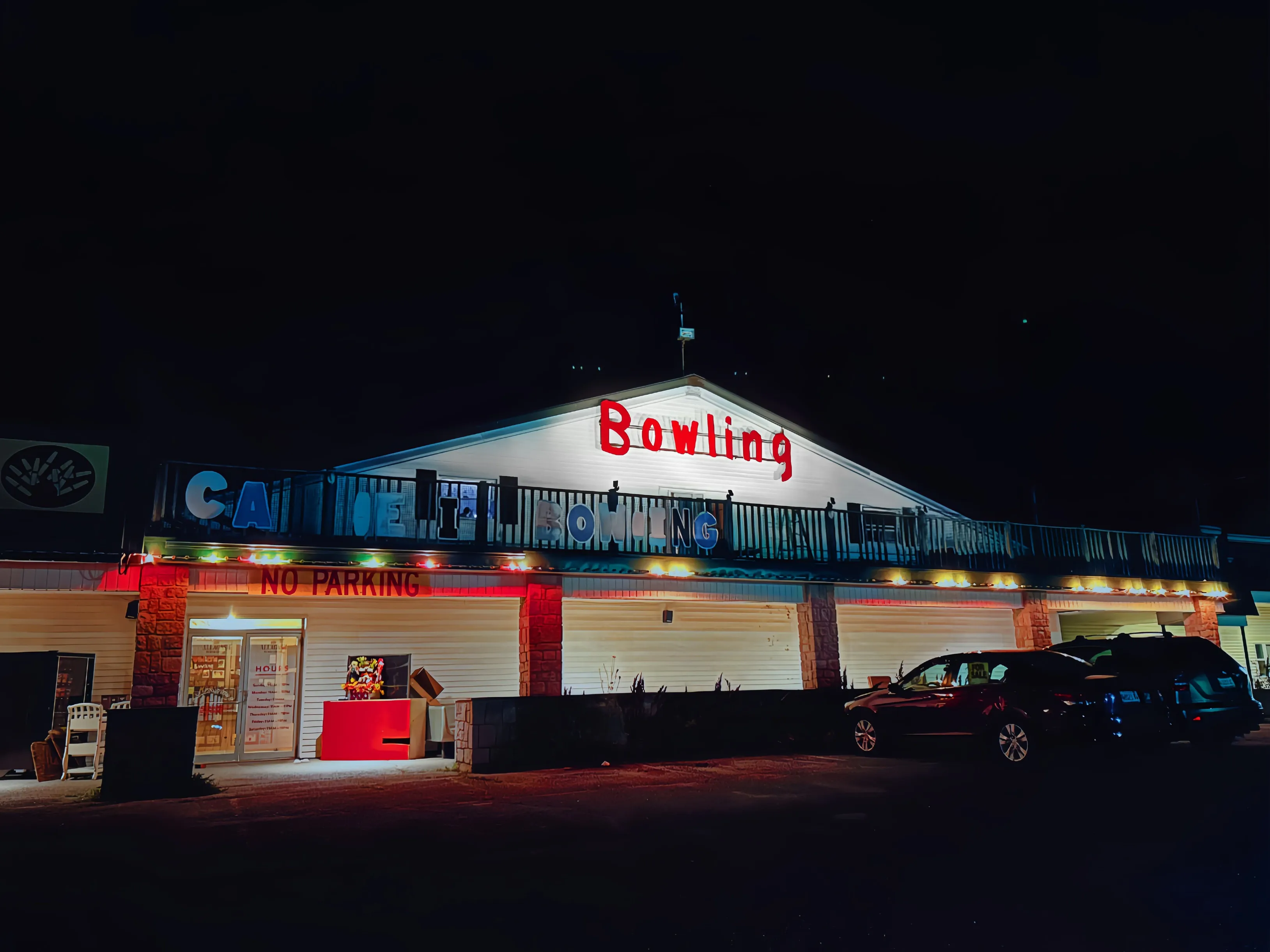 The Ellsworth candlepin alley at night, its neon “Bowling” sign lit above the entrance.