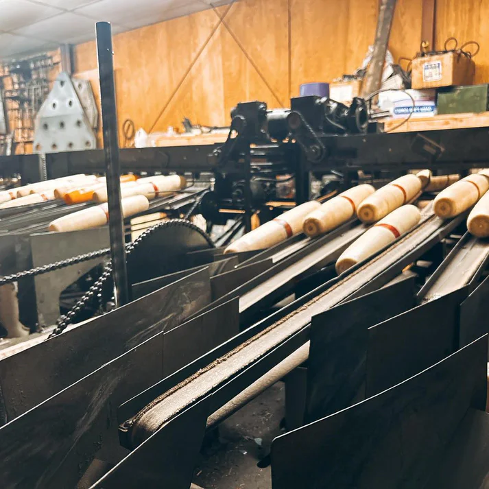 Antique pin-setting machinery, its wooden pins lined up on the rails.